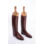 A pair of brown leather riding boots: (possibly a size 8),