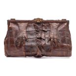 An early 20th century brown crocodile skin handbag: ( poor condition) together with a pair of mid