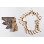 WITHDRAWN A Victorian yellow metal mounted otter tooth necklace: together with a memento mori