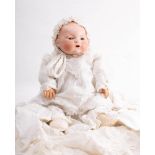 An Armand Marseille bisque head baby doll: moulded hair with sleeping eyes,