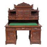 A Chinese carved wood pedestal desk, early 20th century,: with all over decoration of flowers,
