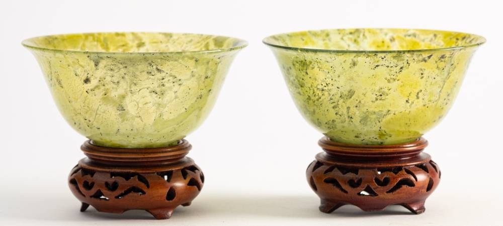 A pair of Chinese jadeite bowls: with rounded sides and everted rims,