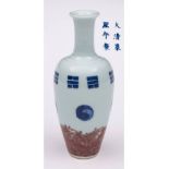 A Chinese porcelain vase: of slender oviform with raised neck and flaring rim painted in blue with