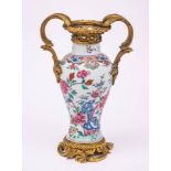 A Chinese ormolu-mounted famille rose baluster vase: brightly enamelled with tree peony,