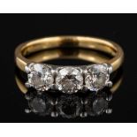 An 18 carat gold three stone diamond ring,: the three brilliant diamonds approximately 1.