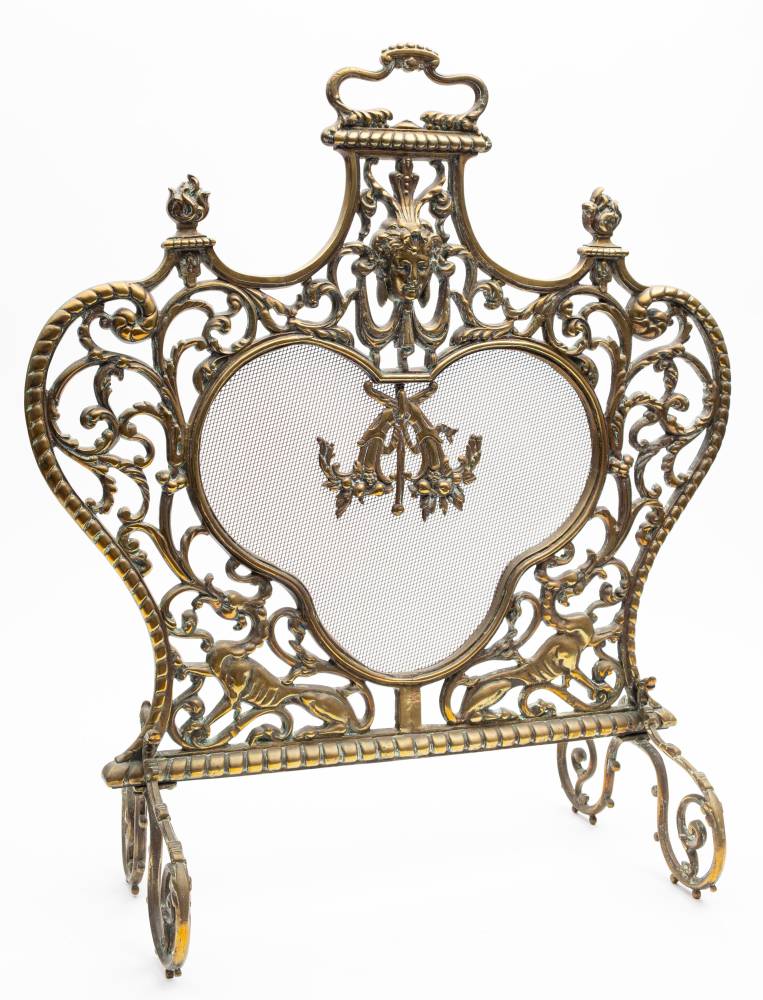 A 19th century cast brass and mesh fire screen: of cartouche-shaped outline,