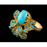 An Iranian turquoise ring,: the oval cabochon turquoise in a claw setting,