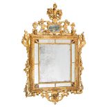 An early 19th century carved giltwood rectangular marginal wall mirror:, surmounted by flowerheads,