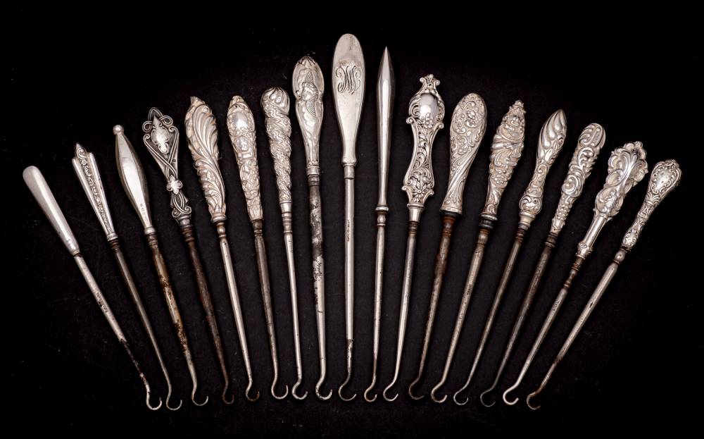 A collection of seventeen assorted small silver-handled button hooks,