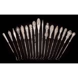 A collection of seventeen assorted small silver-handled button hooks,