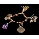 A gold charm bracelet: the faceted belcher links suspending various charms,