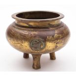 A Chinese bronze and gilt decorated tripod censer: of plain circular form.
