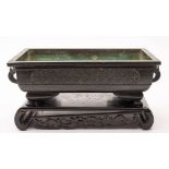 A Chinese bronze rectangular planter and a pewter two-handled bowl and cover: the planter with
