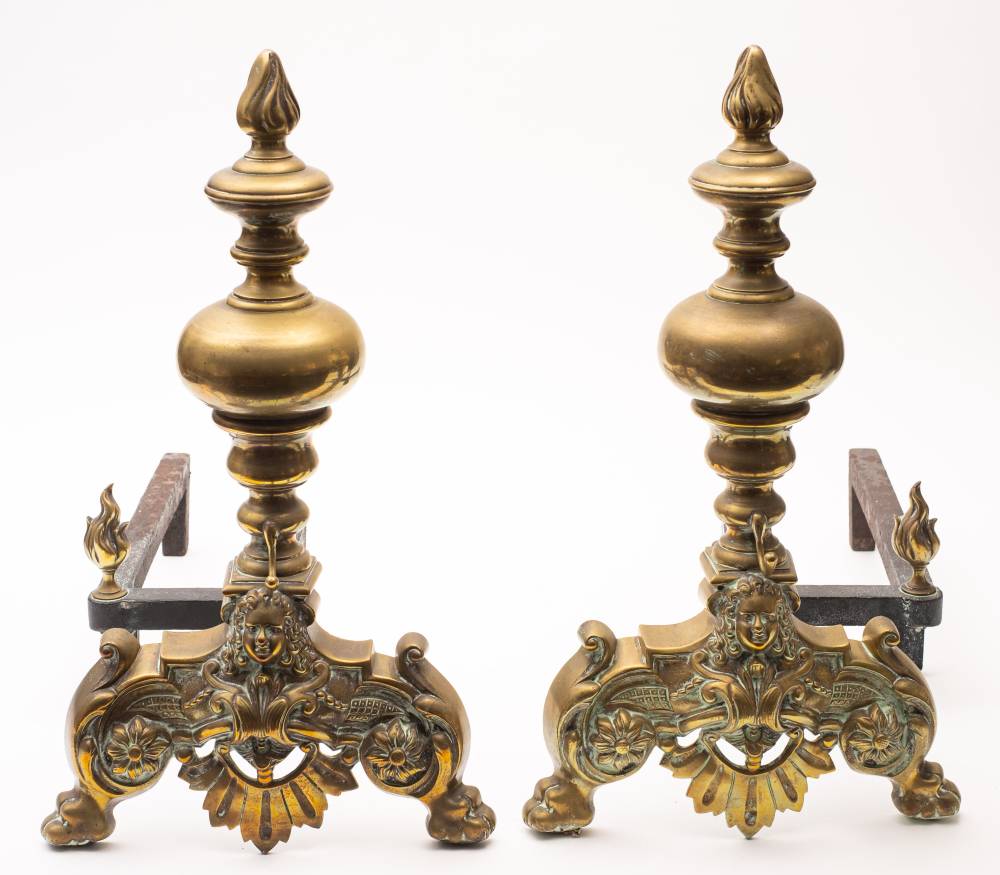 A pair of late 18th /early 19th century brass and iron andirons: the knopped stems with flame