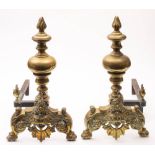 A pair of late 18th /early 19th century brass and iron andirons: the knopped stems with flame