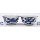 A pair of Chinese blue and white 'phoenix' bowls: each painted with a phoenix, peony and rockwork,
