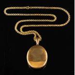 A locket pendant,: the oval locket pendant on a fancy link chain, stamped 9ct, locket 6.