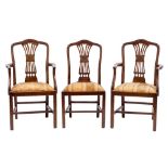 A set of four mahogany and upholstered dining chairs in Hepplewhite taste, 19th century,