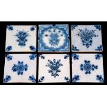 A group of six 18th century English blue and white delftware tiles: floral subjects comprising a