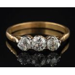 A diamond three stone ring,: set with three old brilliant cut diamonds, approximately 0.