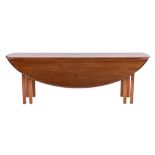 A mahogany wake table in George III style,: the oval top with twin drop leaves and moulded edges,