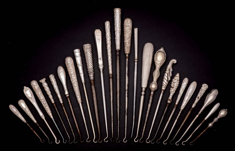 A collection of twenty five assorted of silver plated and silver-handled button hooks: with steel