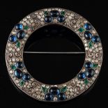 A German 1920s paste brooch,: the circular brooch set with cabochon blue paste,