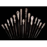 A collection of fifteen assorted silver-handled button hooks,
