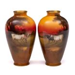 A pair of Royal Doulton vases: of oviform decorated with cattle in a sunset landscape by William