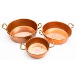 Three 19th century graduated copper preserve pans: of circular outline, with loop carrying handles,