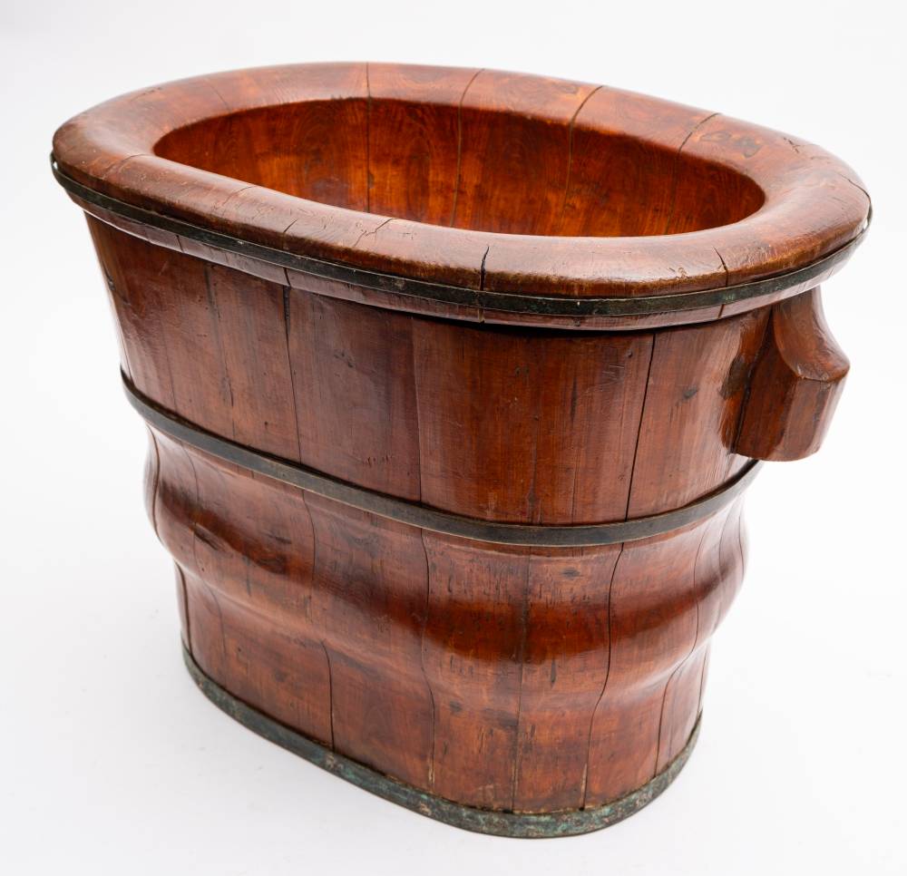 A Chinese softwood and metal bound basin and stand: of oval outline and coopered construction,