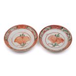 A pair of Chinese swatow saucers: each enamelled in red, green and yellow with a peach spray,