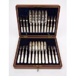 An early 20th century set of twelve plated fruit knives and twelve forks: with foliate engraved