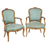 A pair of French carved beech wood fauteuils in the Louis XV taste:,
