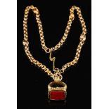 A foil backed quartz set fob,: with chased foliate decoration, on a fancy link chain, fob 2.