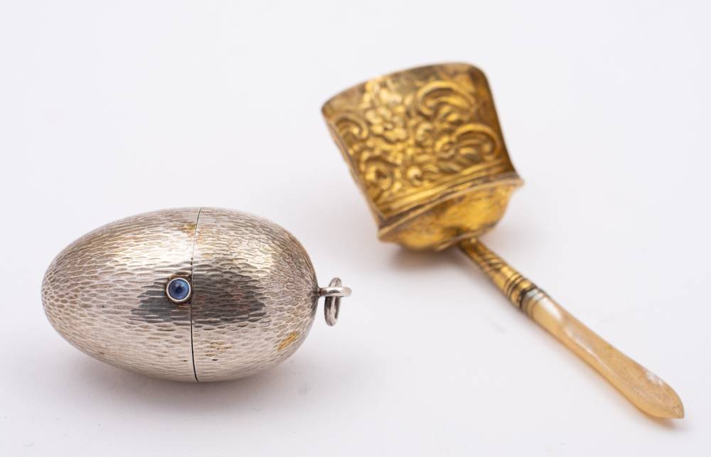 A continental silver cotton reel and needle holder,