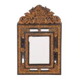 A Dutch ebonised wood and gilt repousse metal mounted wall mirror in 17th century style,