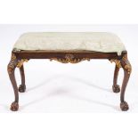 A carved and parcel gilt walnut long stool in George II style, late 19th century,