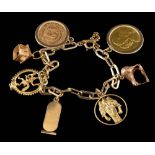 A gold coloured charm bracelet,: the polished link bracelet with various gold coloured charms,