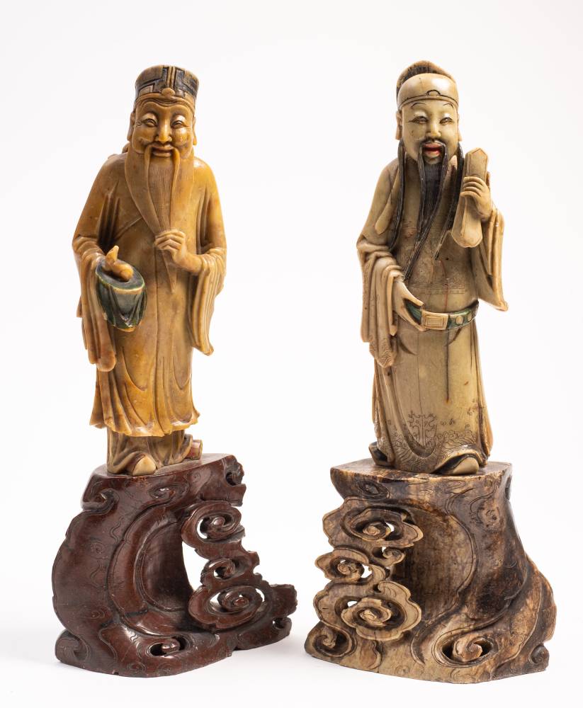 A pair of Chinese carved soapstone figures of two Immortals: Lan Ts'ai-ho and possibly Ts'ai-shen,