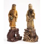 A pair of Chinese carved soapstone figures of two Immortals: Lan Ts'ai-ho and possibly Ts'ai-shen,