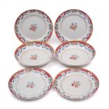 A set of four Chinese famille rose dishes and a pair of matching deep dishes: each painted with a