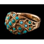 A gold coloured ring,: the openwork central section set with circular cabochon blue stones,