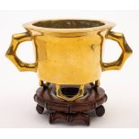 A Chinese bronze censer: of cylindrical form with flat rim and faux bamboo feet and handles,