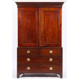 A George III mahogany linen press, circa 1800,: with dentilled cornice above twin panelled doors,