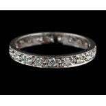 An 18 carat gold and diamond eternity ring,: set with brilliant cut diamonds,