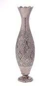 A Middle Eastern silver vase: with flared rim and slender ovoid body with floral decoration raised