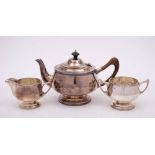 A George V silver three-piece circular tea service, maker Walker & Hall, Sheffield,