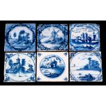 A group of six 18th century English blue and white delftware tiles: comprising ruined buildings