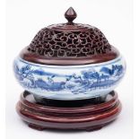 A Chinese blue and white tripod censer: of compressed globular form, painted with buildings,